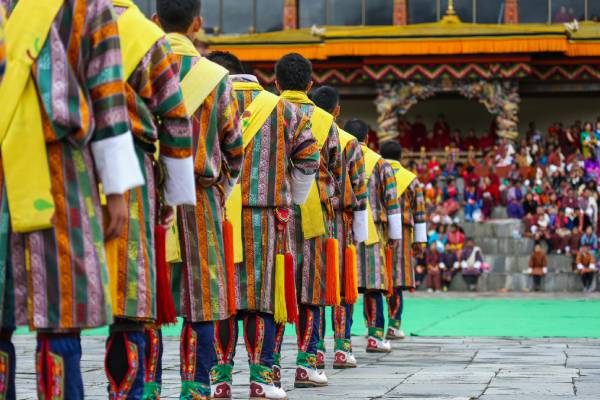 Bhutanese people in colourful traditional dress at a festival